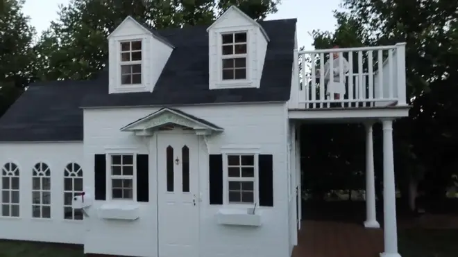 Stormi peaks out of her balcony on her new playhouse, which is similar to one her mother Kylie used to have as a child.