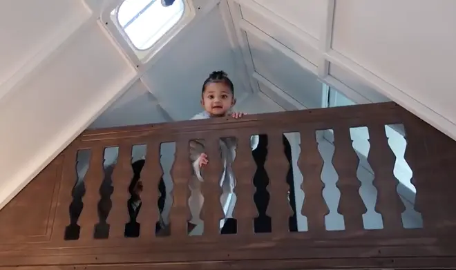 Stormi looks down from the top floor of her playhouse.
