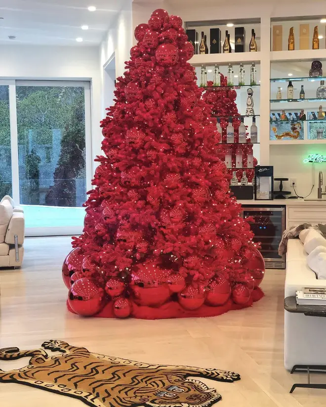 Alongside the red Christmas tree, Tyga's collection of alcoholic beverages sit on full display.