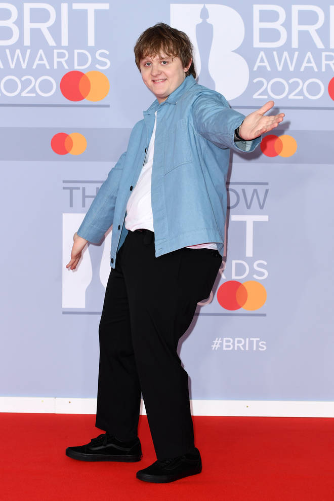 Lewis Capaldi cut a casual figure in a blue shirt and black trousers.