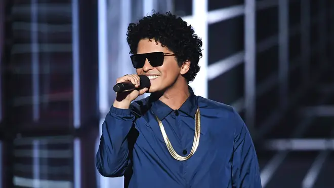 Bruno Mars speaks onstage during the 2018 Billboard Music Awards at MGM Grand Garden Arena on May 20, 2018 in Las Vegas, Nevada.