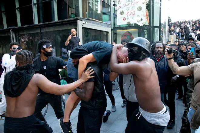 Patrick Hutchinson carries injured man amid far-right riots