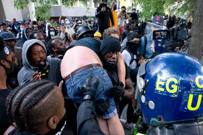 Far-Right supporter carried to safety by Black Lives Matter supporter