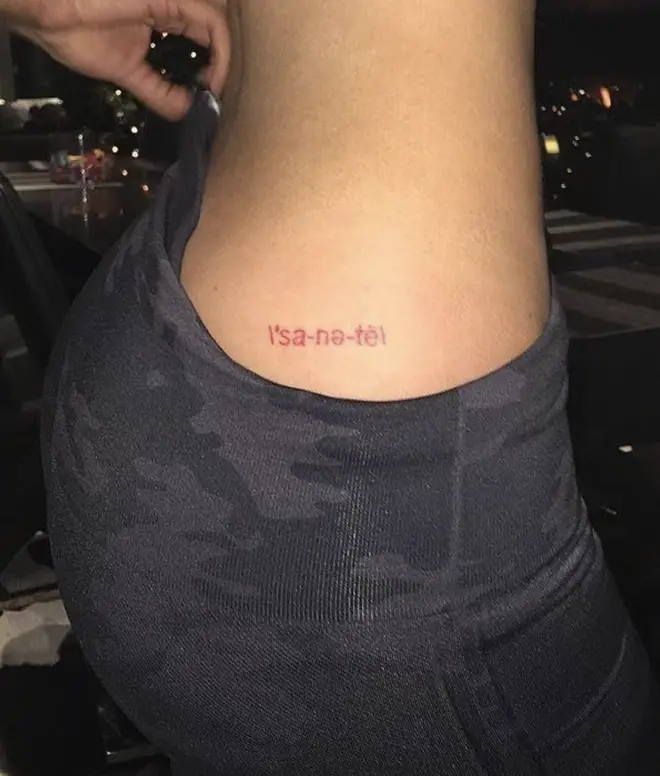 Kylie got the phonetic spelling of 'sanity' on her hip in red ink.