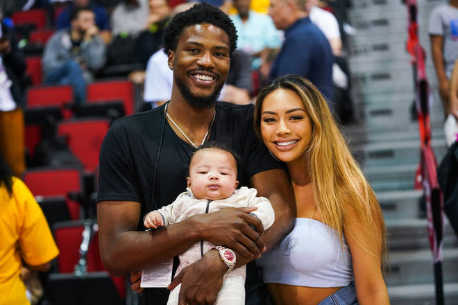 Malik Beasley and Montana Yao pose with their son Makai at an NBA Summer league game in July 2019.