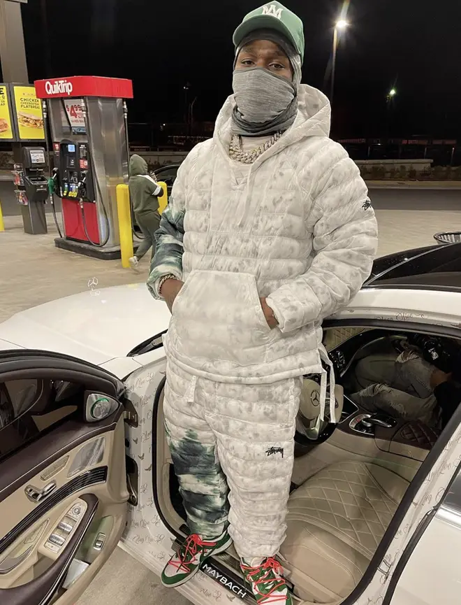 DaBaby poses inside a Maybach on set for the "Beatbox" freestyle music video