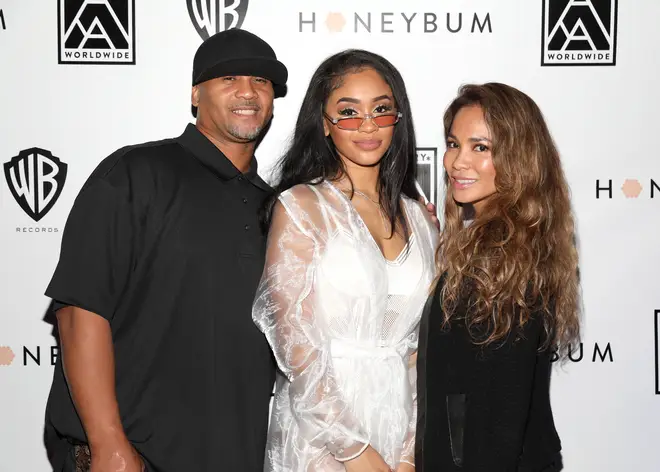 Saweetie poses with her parents Johnny and Trinidad at her "High Maintenance" Listening Event in 2018.