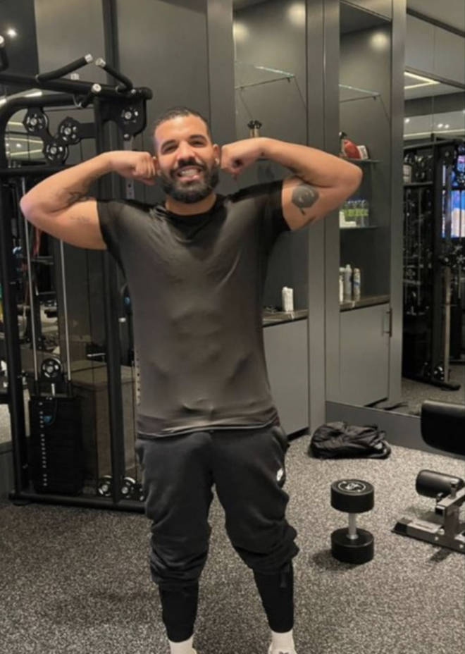Drake shows off his muscles in his gym room in the mansion.