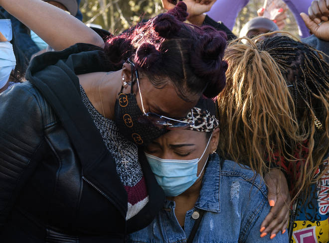 DMX's ex-wife Tashera Simmons (L) and fiancee Desiree Lindstrom (R) hug at the vigil hosted by the Ruff Ryders.