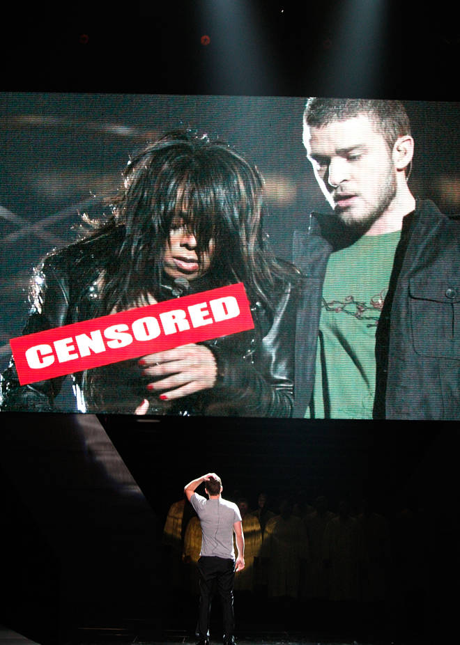 Justin Timberlake stands onstage in front of a video of himself and Janet Jackson from Super Bowl XXXVIII onstage at the 2008 ESPY Awards