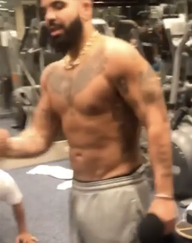 Drake reposts video of him in the gym, flexing his muscles to the camera.