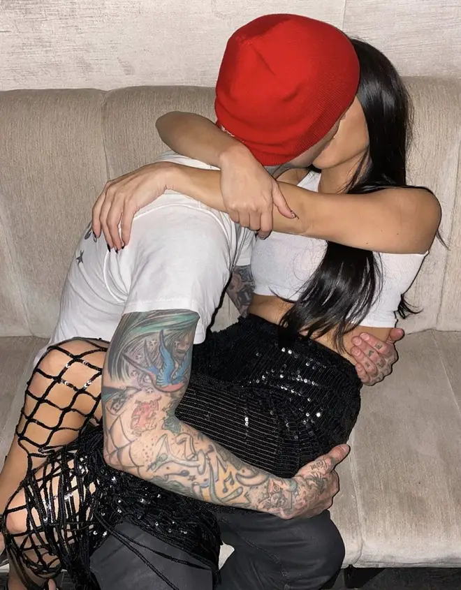 Travis Barker shares photo of him kissing Kourtney Kardashian on Instagram.