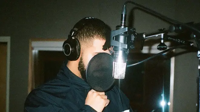 Drake wearing headphones
