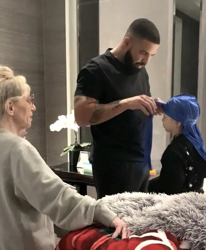 Drake shares a photo of him tying Adonis' durag, with his mother Sandi Graham in attendance.