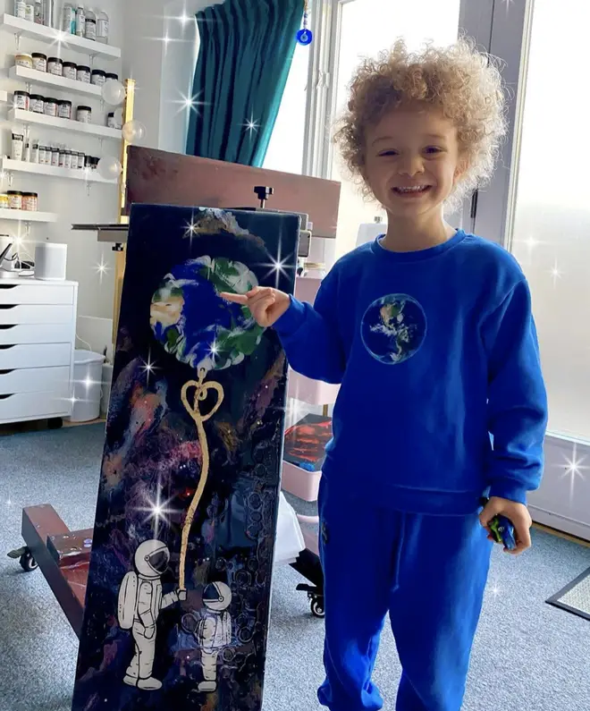 Adonis poses in-front of a painting his mother made for #EarthDay
