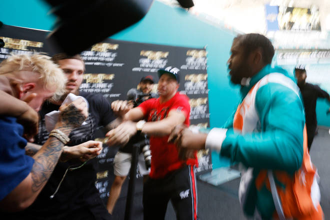 Jake Paul and Floyd Mayweather scuffle at the Hard Rock Stadium on May 06, 2021.