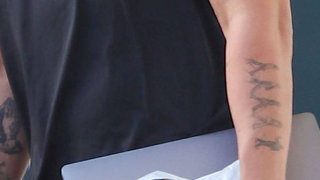 The Beatles tattoo on his left forearm