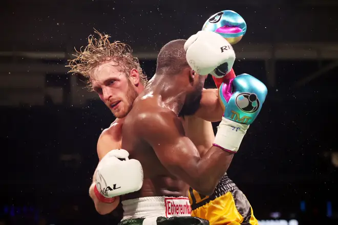 Floyd Mayweather exchanges blows with Logan Paul during their exhibition boxing match at Hard Rock Stadium on June 06, 2021