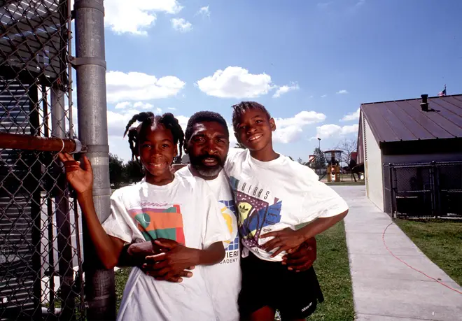 Tennis players Venus and Serena Williams pose with their dad Richard,  in Compton, 1991.