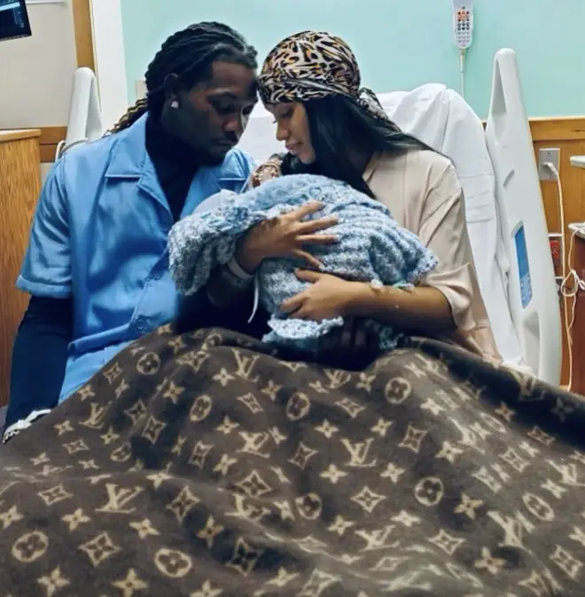 Offset and Cardi B holding their little boy while being pictured at the hospital.