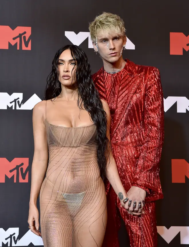 Megan Fox holds her beau Machine Gun Kelly's hand on the red carpet.