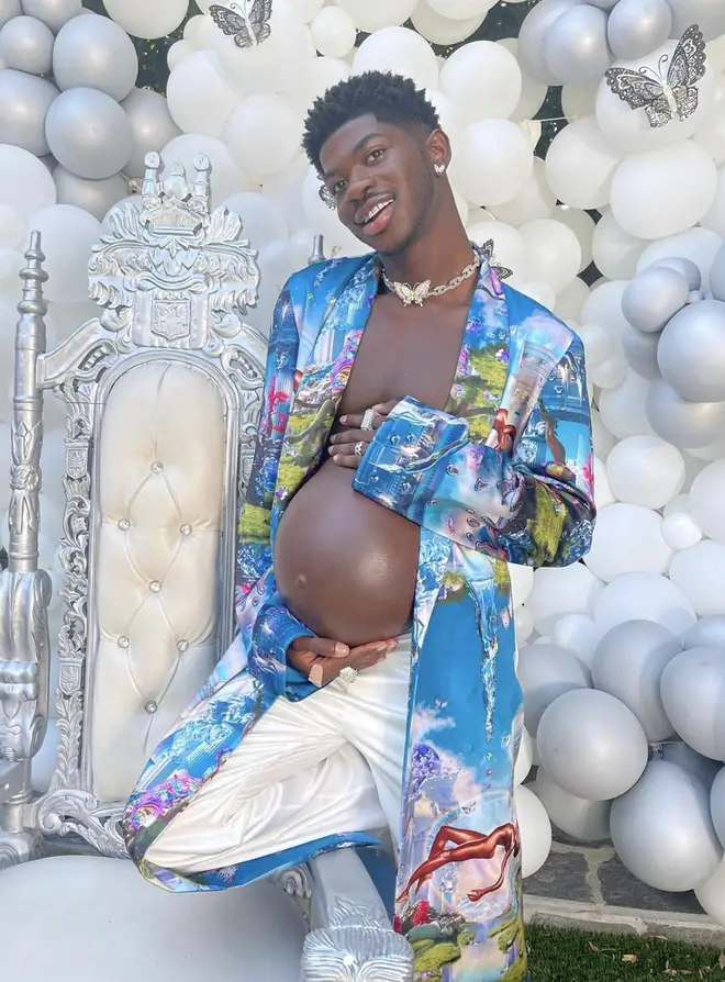 Lil Nas X poses with his 'pregnant baby bump' at his baby shower.