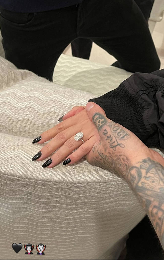 Kourtney's engagement ring is an oval shaped stone on a simple diamond band.