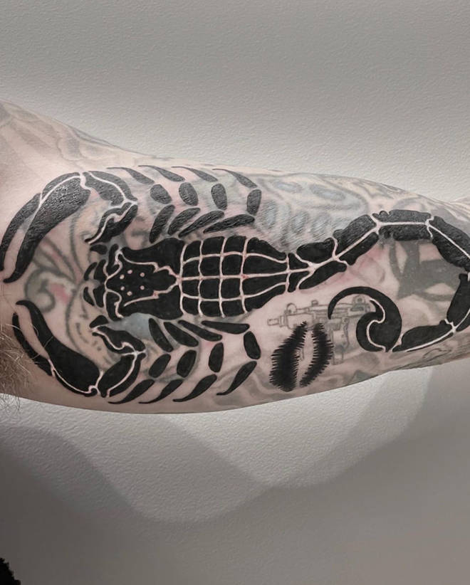 Travis Barker shows off his new ink of a giant scorpion, covering his tattoo dedicated to his ex Shanna Moakler.