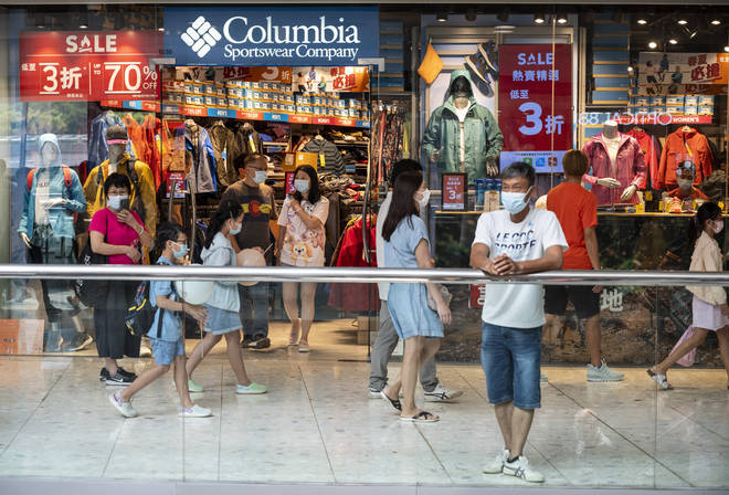 Shoppers walk past American Columbia Sportswear brand
