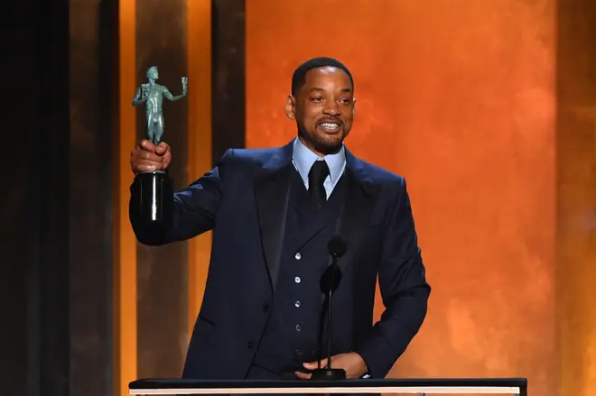 Will Smith accepts the award for Outstanding Performance by a Male Actor in a Leading Role for King Richard onstage during the 28th Annual Screen Actors Guild (SAG) Awards at the Barker Hangar in Santa Monica, California, on February 27, 2022