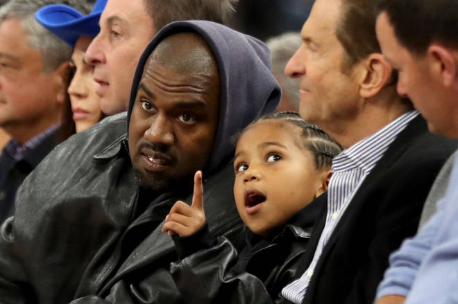 Kanye West and his son, Saint West front row at the Golden State Warriors game against the Boston Celtics in the second quarter at Chase Center in San Francisco, Calif., on Wednesday, March 16, 2022