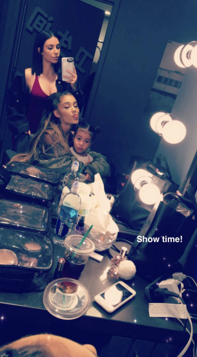 Kim Kardashian shared a photo with Ariana Grande holding her daughter, North West, in March 2017.