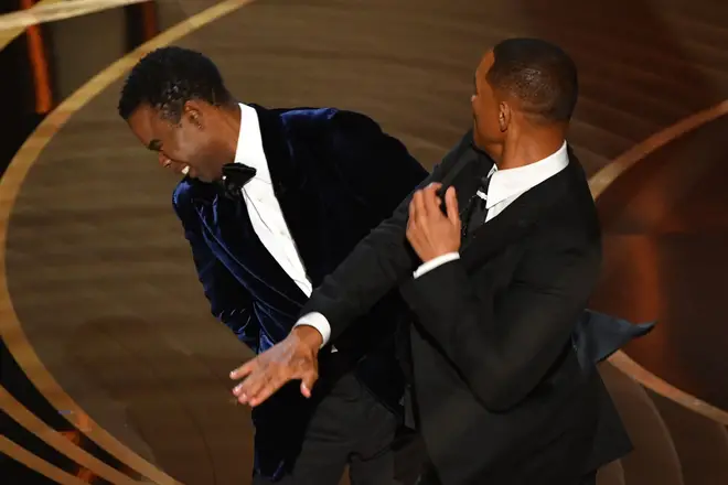 Will Smith (R) slapped Chris Rock (L) across the face on stage at the Oscars on Sunday (Mar 27)