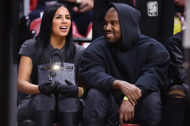 Kanye West and girlfriend Chaney Jones attend a game between the Miami Heat and the Minnesota Timberwolves at FTX Arena on March 12, 2022 in Miami, Florida