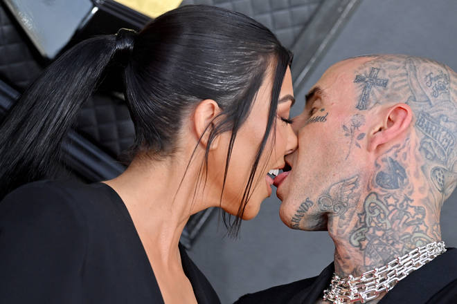 Kourtney Kardashian and Travis Barker packed on the PDA at the 64th Annual GRAMMY Awards.