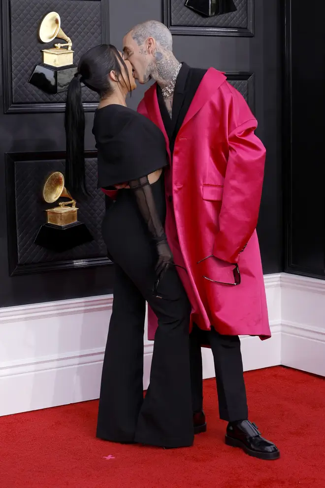 Kourtney Kardashian and Travis Barker lock tongues on the red carpet at the Grammys