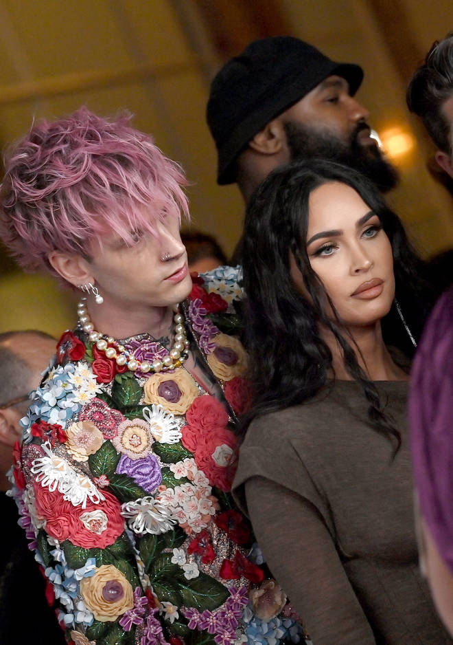Megan Fox swerves Machine Gun Kelly's kiss on the red carpet at The Daily Front Row's 6th Annual Fashion Los Angeles Awards.