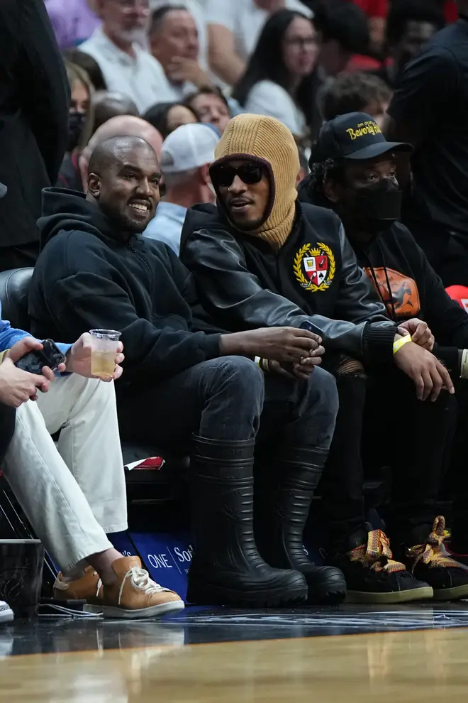 Kanye West and Future attend the game between the Minnesota Timberwolves and the Miami Heat on March 12, 2022 at FTX Arena in Miami, Florida