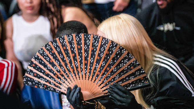 Tory Lanez and Madonna hid behind her fan while sitting at the ringside together