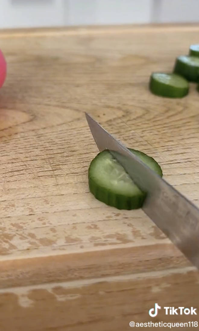 Penelope cutting a cucumber correctly