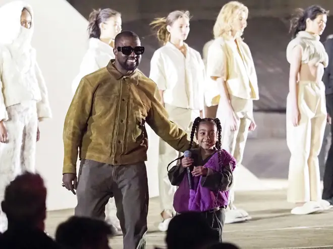 Kanye and his daughter North pictured at a Yeezy fashion show