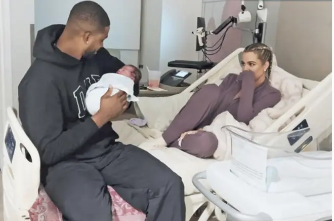 Khloe and Tristan with their new child as seen in the premiere of The Kardashians.