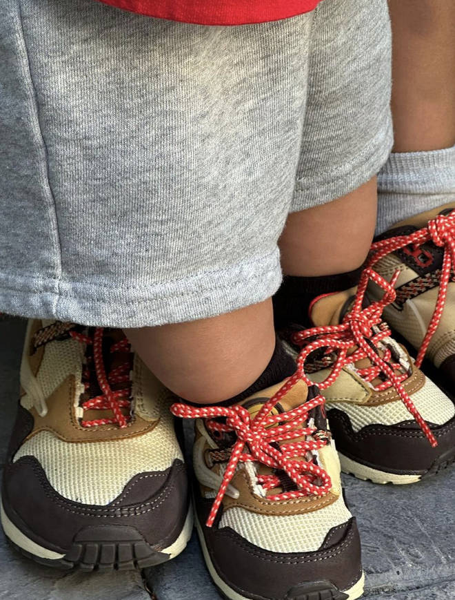 Stormi and her brother wearing matching shoes designed by their dad Travis Scott.