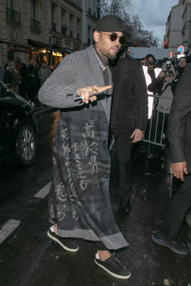 Chris Brown attended Paris Fashion Week before he was arrested following a rape claim