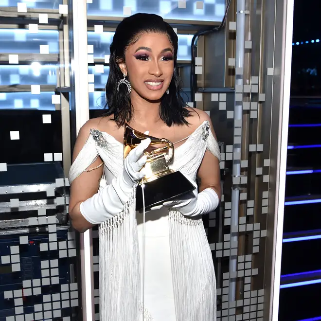 Cardi B clutching her Grammy Award for 'Best Rap Album.'