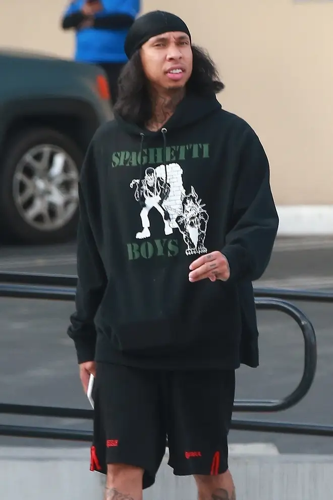 Tyga was sporting a long, shoulder-length hairstyle.