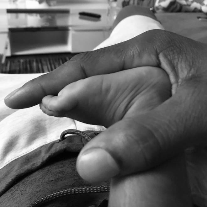 The singer sparked speculation after posting a photo of his newborn son's foot on social media.