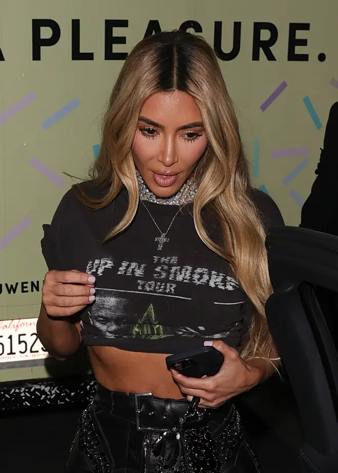 Kim wore a cropped tour tee and leather trousers.