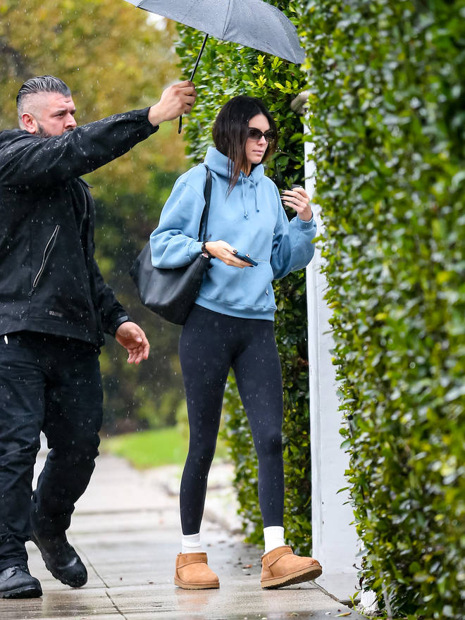 Kendall was papped with a member of staff holding an umbrella for her.