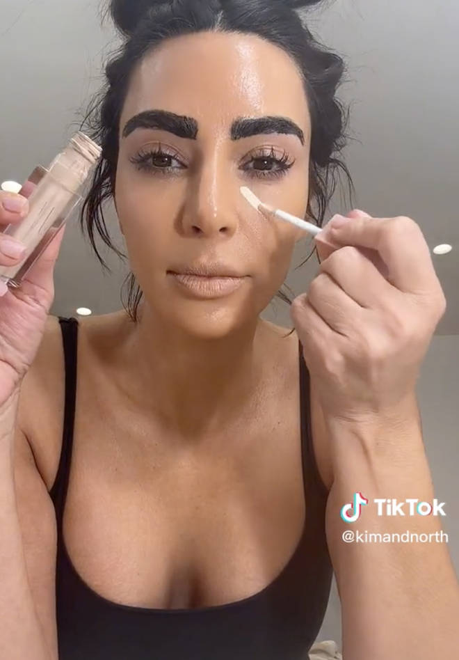 Kim then applied a thick layer of makeup to her face.